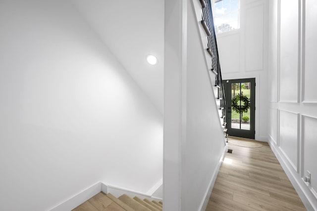 stairway featuring wood-type flooring