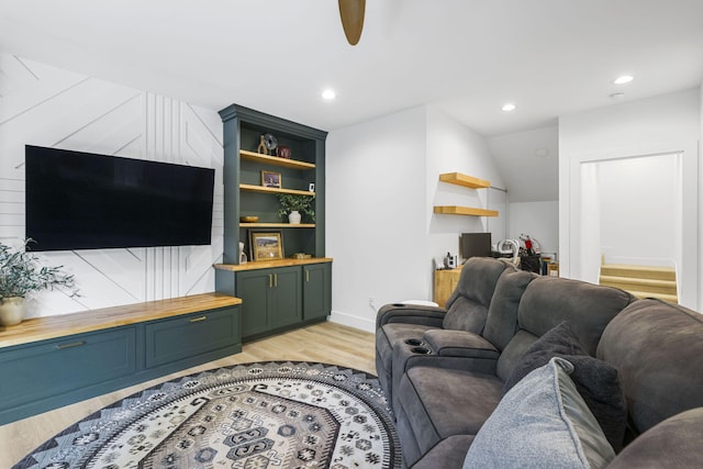 living room with light wood-type flooring and ceiling fan