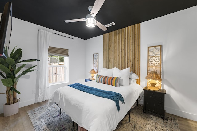 bedroom with ceiling fan and light hardwood / wood-style floors