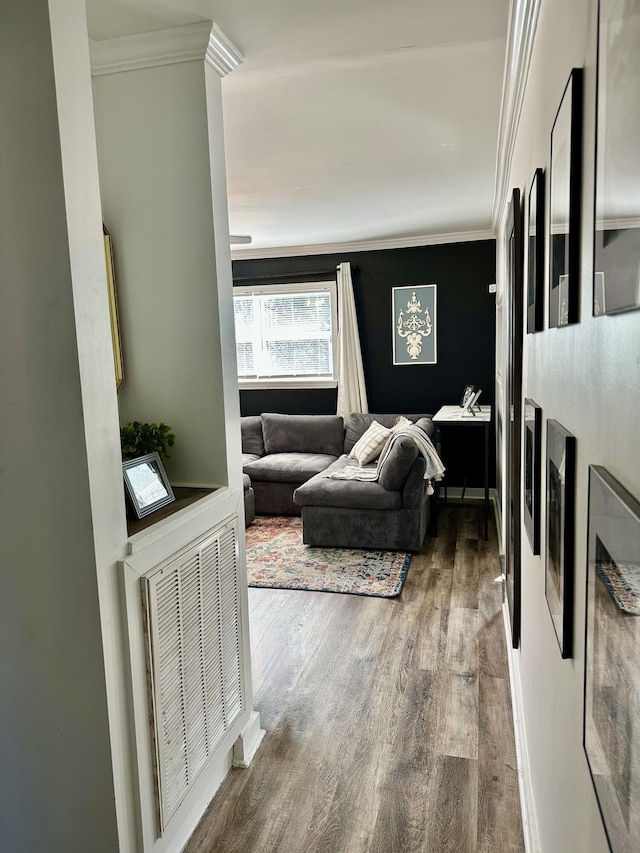 interior space with wood finished floors, visible vents, and crown molding