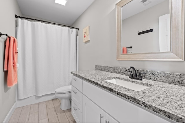 bathroom featuring shower / bath combination with curtain, visible vents, vanity, and toilet