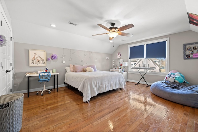 bedroom featuring lofted ceiling, wood-type flooring, and baseboards