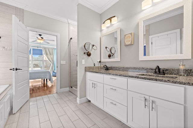 full bath featuring wood finish floors, ornamental molding, ensuite bath, and a sink