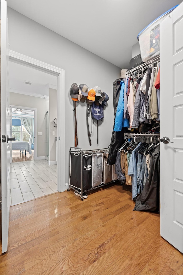 walk in closet featuring light wood-style floors and visible vents