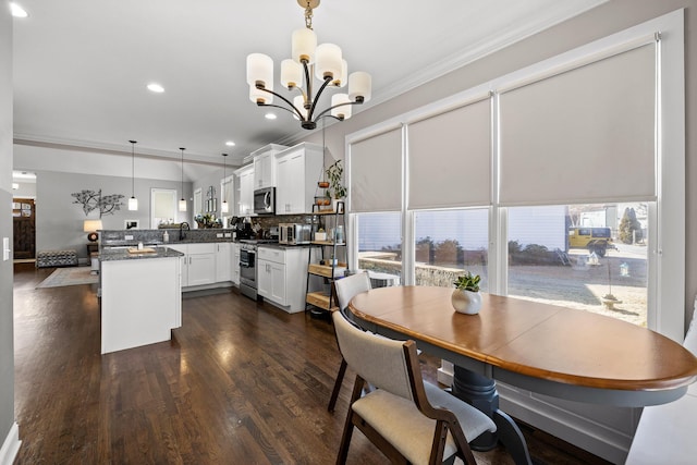 dining space with dark wood-type flooring, recessed lighting, a notable chandelier, and ornamental molding