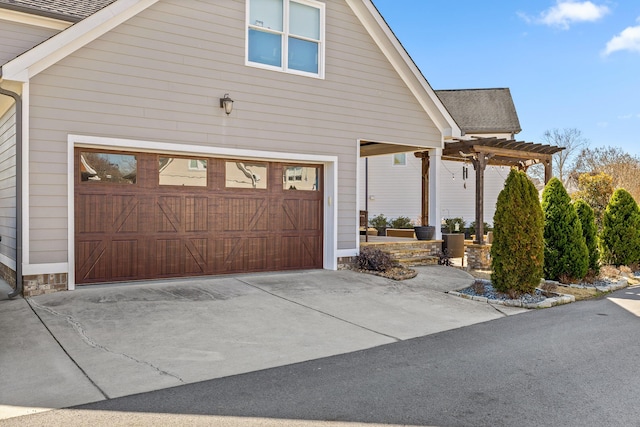 view of side of home featuring a garage, concrete driveway, roof with shingles, and a pergola