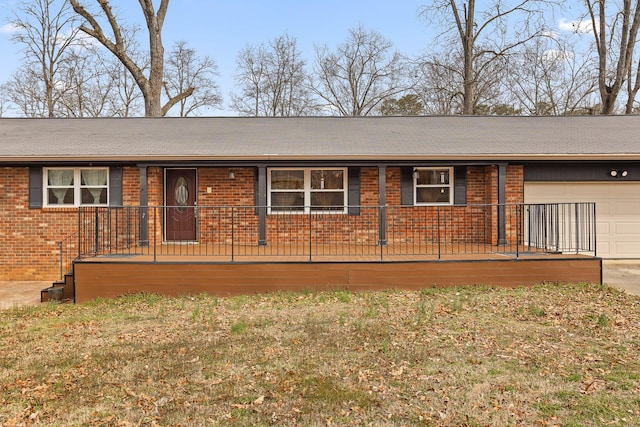 ranch-style home featuring concrete driveway, an attached garage, a front lawn, brick siding, and a porch