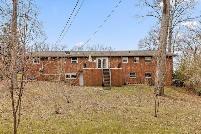 rear view of house with brick siding and stairs