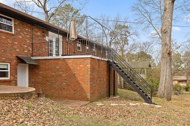 view of home's exterior with brick siding and stairway