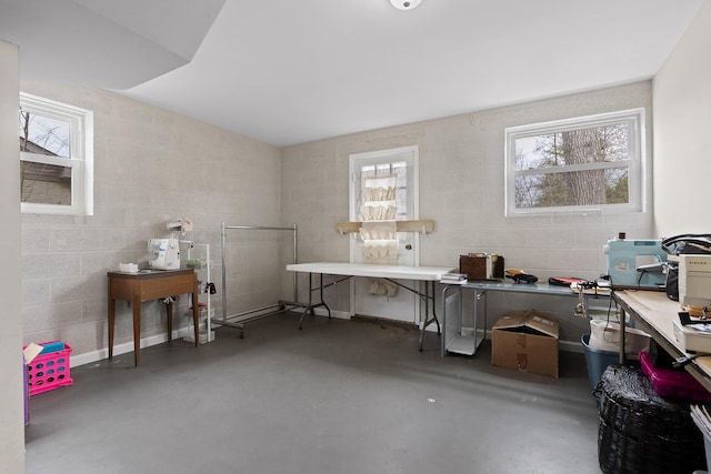 office area featuring concrete block wall and finished concrete floors