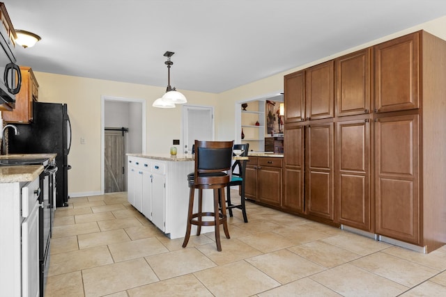 kitchen featuring hanging light fixtures, light tile patterned floors, black range with electric stovetop, and a kitchen island