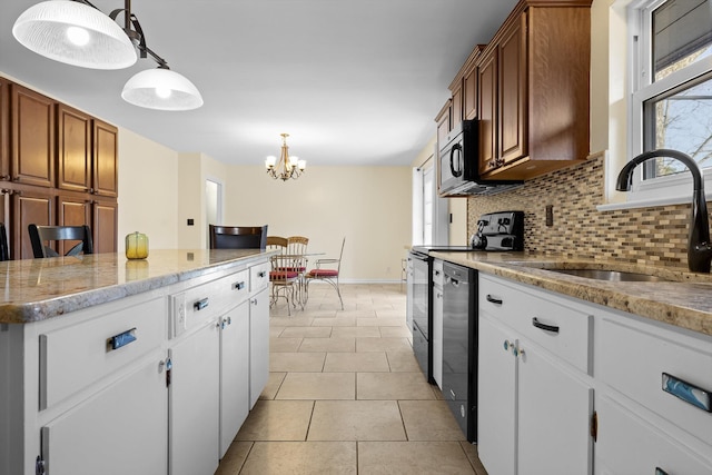 kitchen featuring decorative backsplash, dishwasher, stainless steel microwave, a sink, and a healthy amount of sunlight