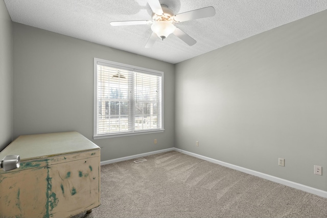 empty room featuring visible vents, baseboards, ceiling fan, carpet floors, and a textured ceiling