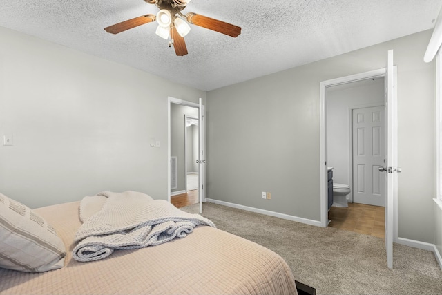 bedroom with baseboards, light carpet, a textured ceiling, and a ceiling fan