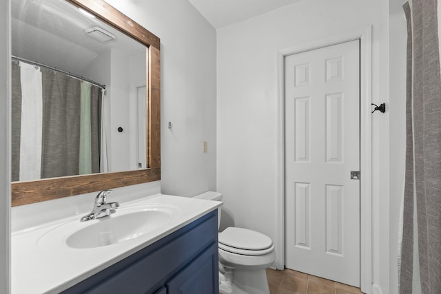 full bathroom featuring vanity, tile patterned floors, and toilet