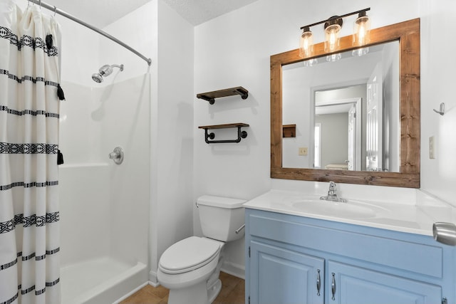 full bath with toilet, a stall shower, vanity, and tile patterned flooring