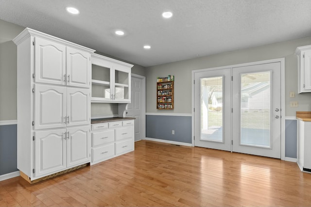 kitchen with recessed lighting, baseboards, light wood-style floors, and white cabinetry