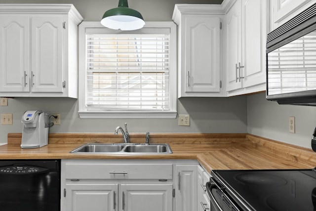 kitchen featuring a sink, black appliances, and white cabinetry