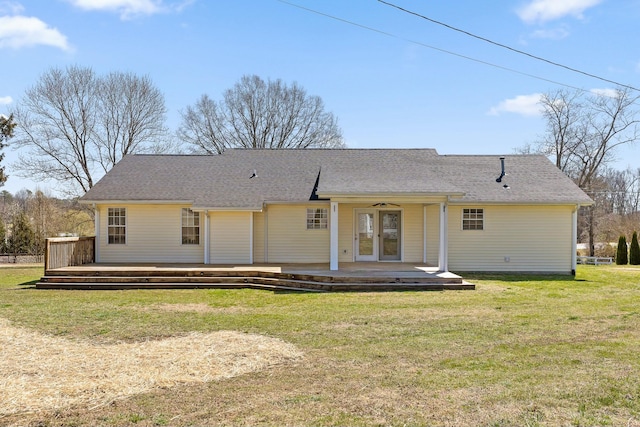 back of property featuring a deck, french doors, a yard, and roof with shingles