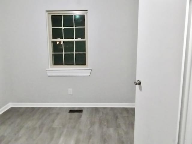 spare room with wood-type flooring