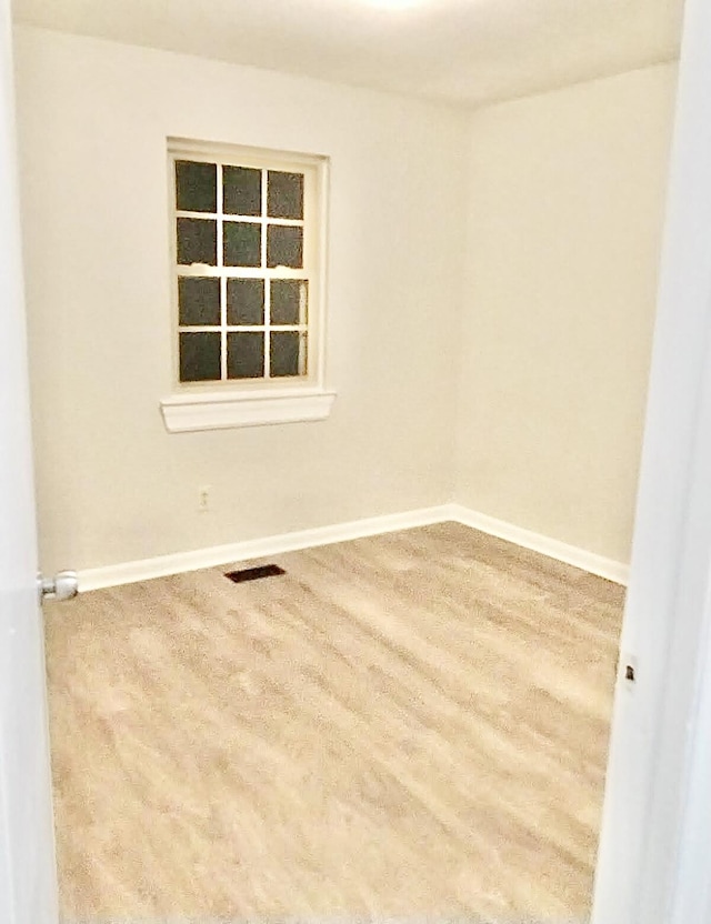 empty room featuring wood-type flooring