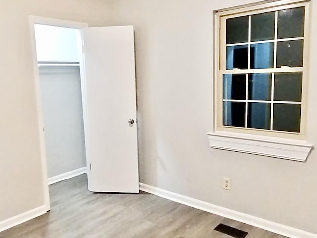 unfurnished bedroom with hardwood / wood-style flooring and a closet