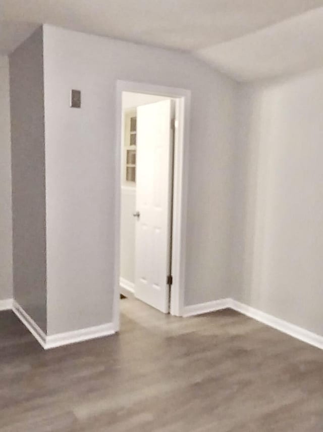 empty room with dark hardwood / wood-style flooring