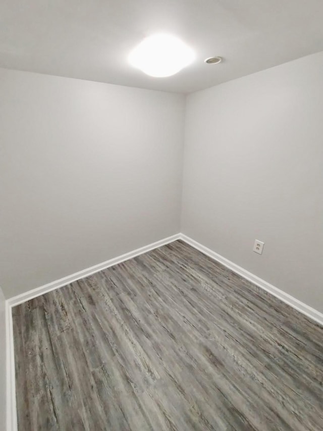 spare room with dark hardwood / wood-style floors