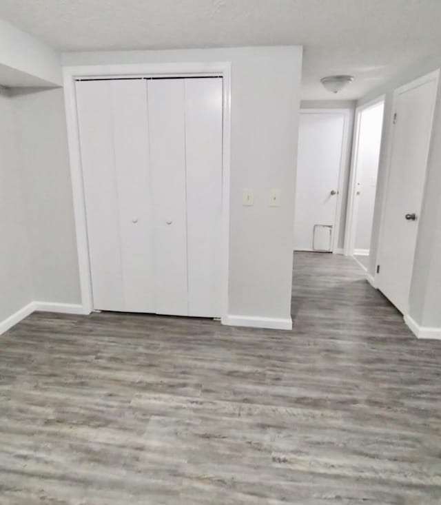 unfurnished bedroom featuring a closet and hardwood / wood-style flooring