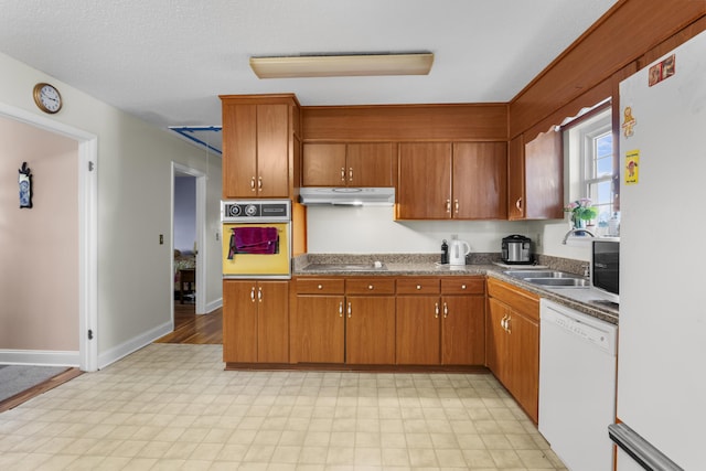 kitchen featuring sink and white appliances