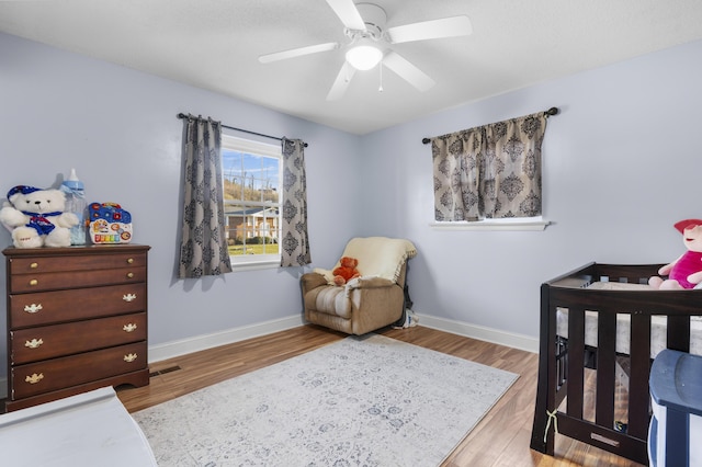 bedroom featuring ceiling fan and light hardwood / wood-style flooring