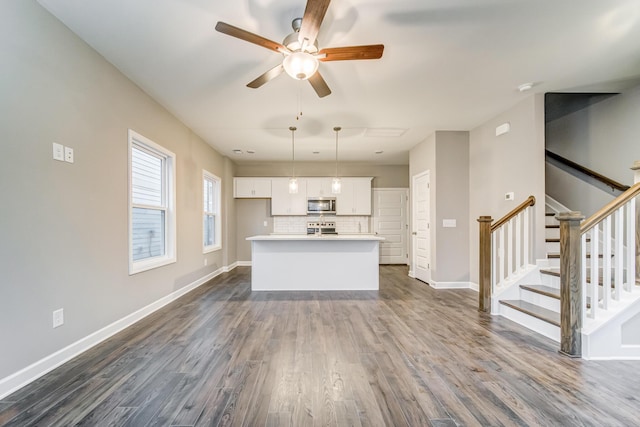 interior space featuring ceiling fan and dark hardwood / wood-style flooring