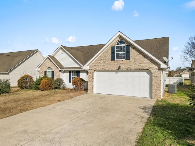 view of front of home featuring central AC unit, a front lawn, and a garage