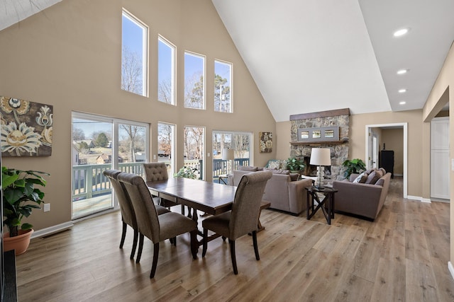 dining area with light wood-style floors, recessed lighting, visible vents, and baseboards