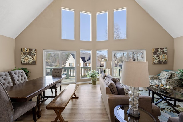 living room with high vaulted ceiling and wood finished floors