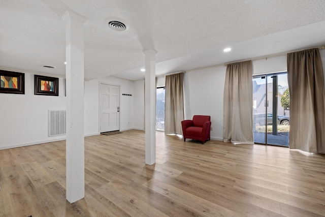 interior space featuring light wood-style floors and visible vents