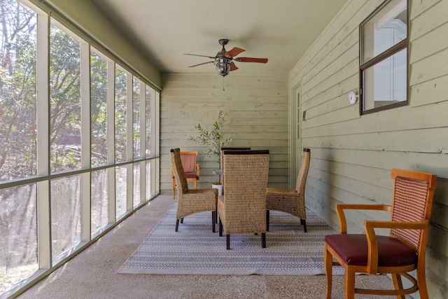 sunroom / solarium featuring ceiling fan