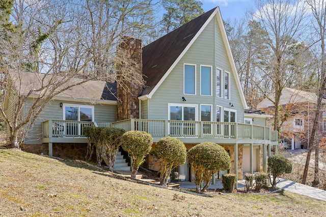 view of front of property with a deck, stairway, a patio area, and a chimney