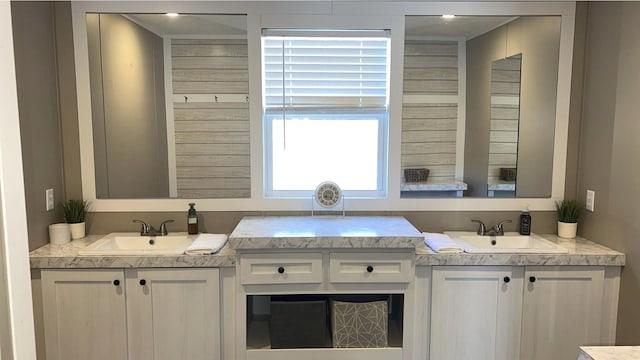 kitchen featuring light countertops, a sink, and white cabinets