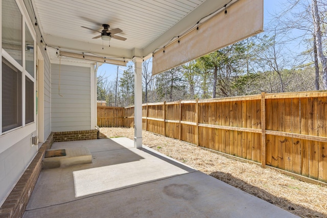 view of patio / terrace featuring fence and a ceiling fan