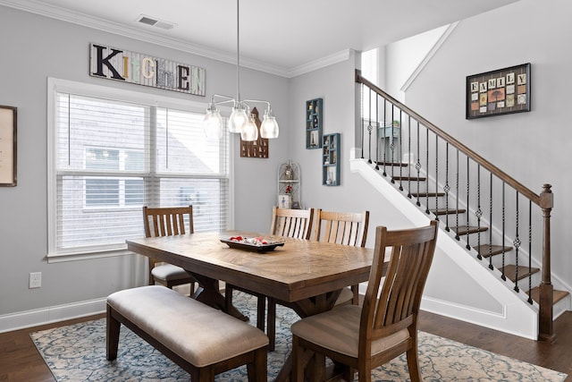 dining room featuring a healthy amount of sunlight, visible vents, baseboards, and wood finished floors