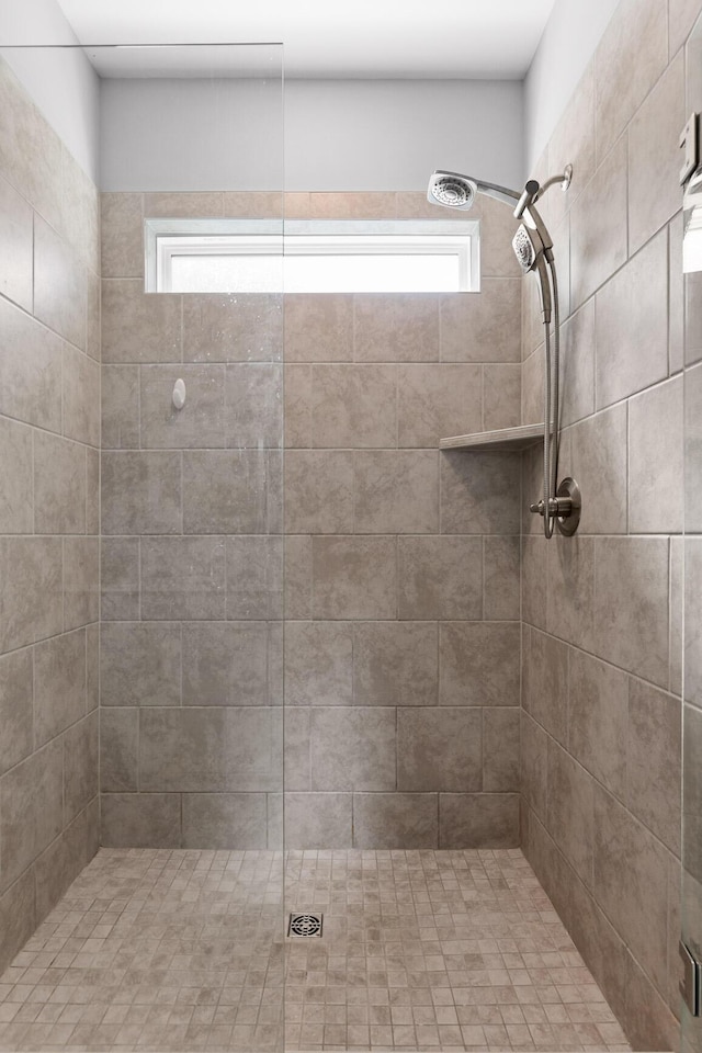 full bathroom with a healthy amount of sunlight and a tile shower