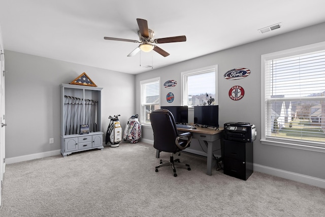 office space with carpet flooring, visible vents, and baseboards