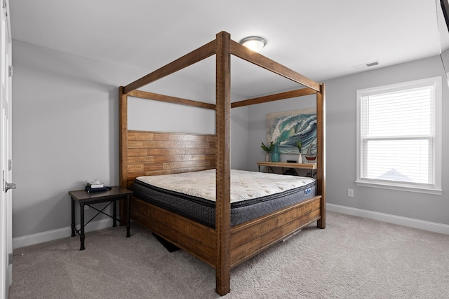 carpeted bedroom with visible vents and baseboards