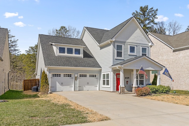 view of front of property with covered porch, fence, concrete driveway, roof with shingles, and a front yard