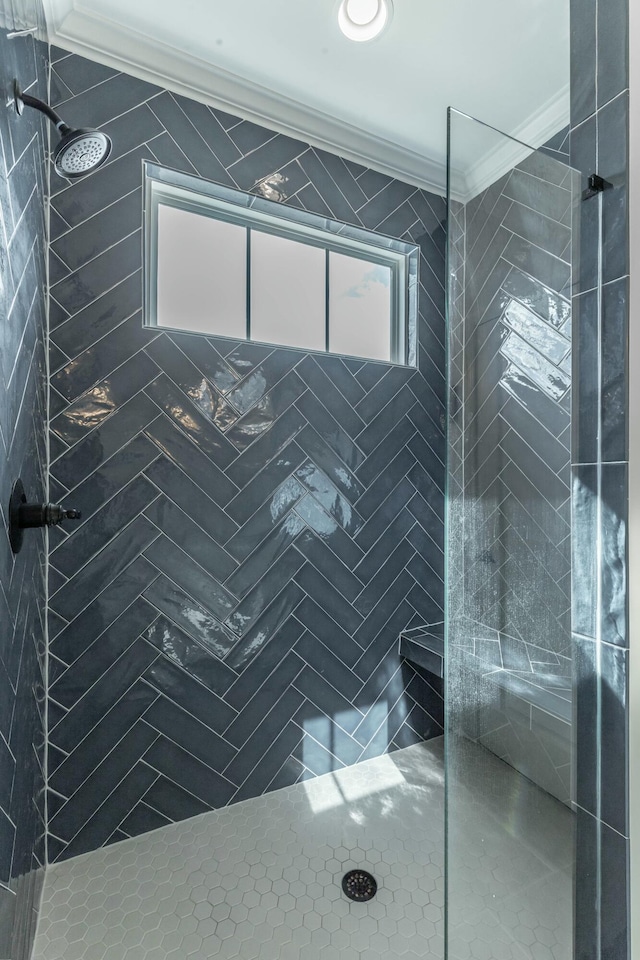 bathroom with ornamental molding and a walk in shower