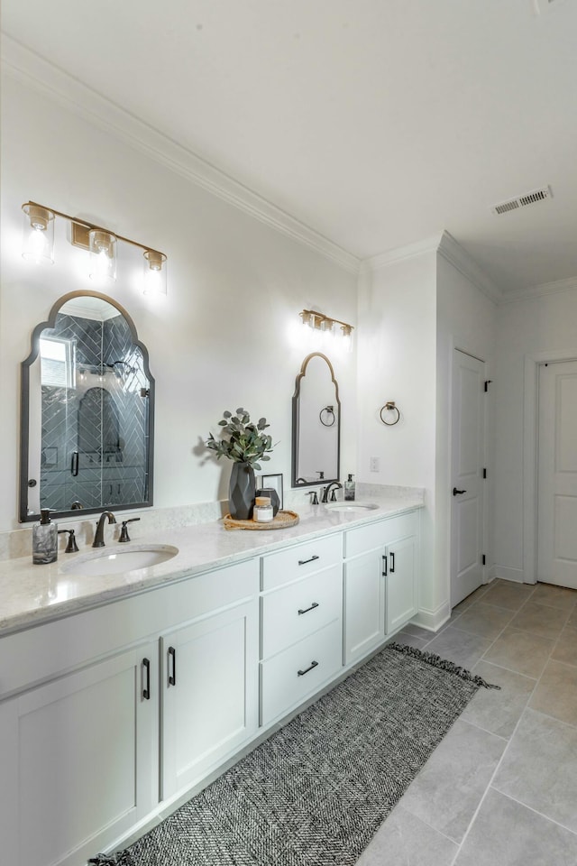 full bath featuring ornamental molding, visible vents, a sink, and double vanity