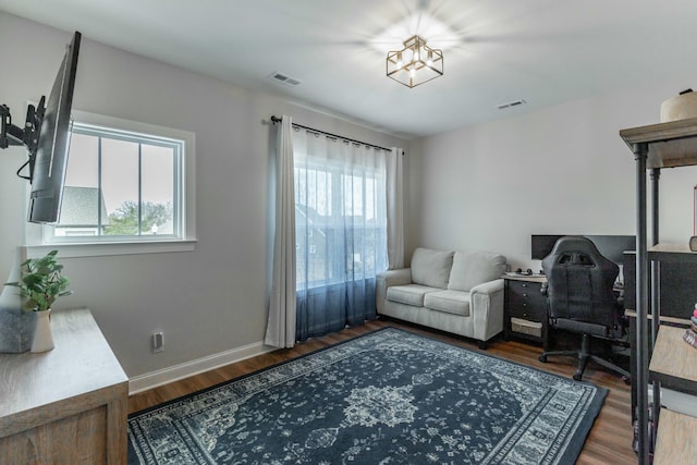 office space featuring dark wood-style floors, visible vents, and a healthy amount of sunlight