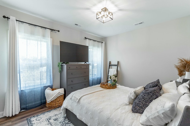 bedroom with visible vents and wood finished floors