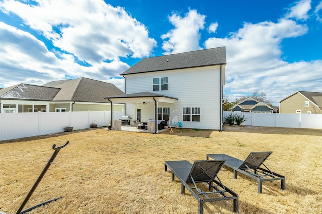 back of property featuring a yard, a fenced backyard, a ceiling fan, and a patio